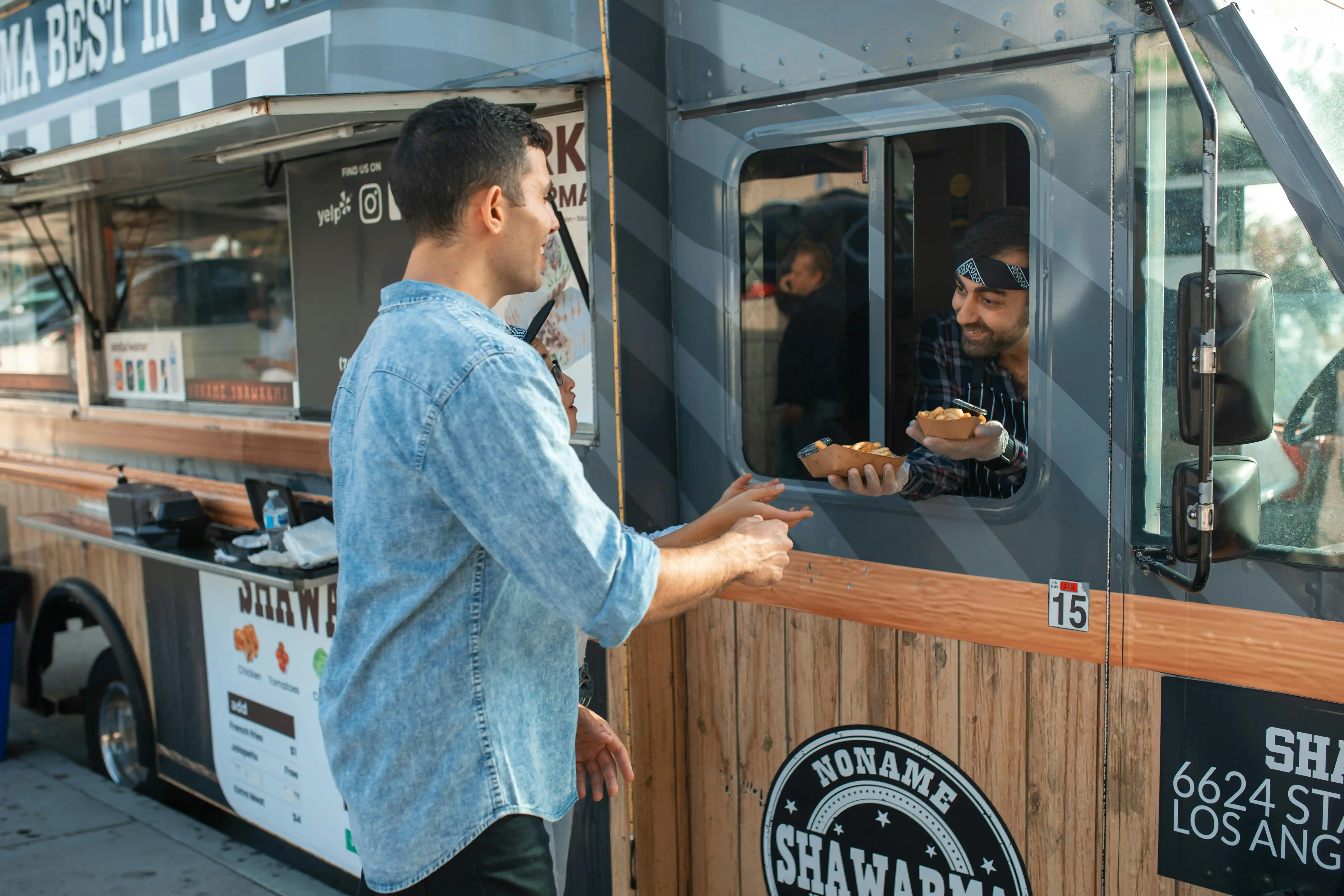 A busy food truck serving a crowd of hungry customers