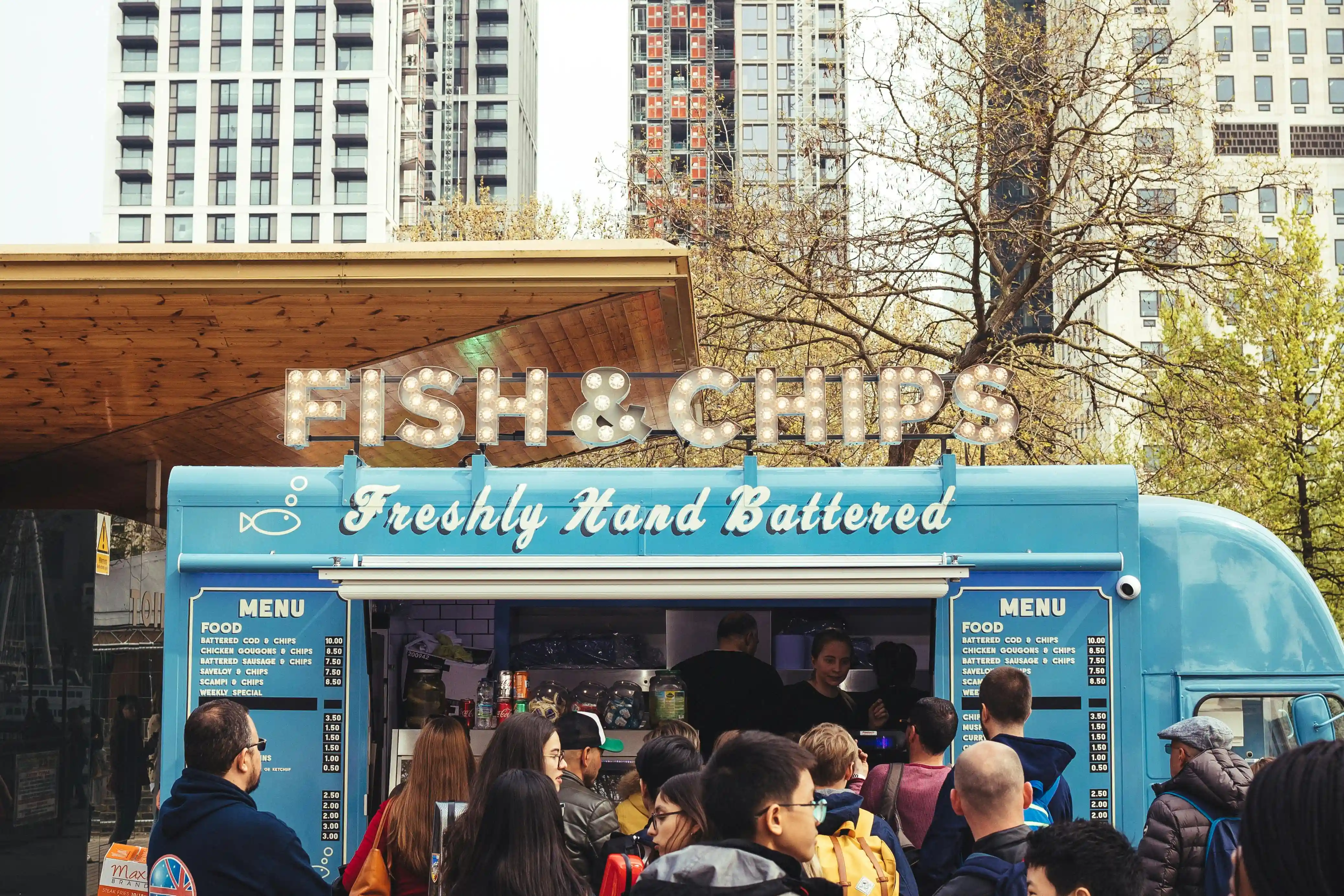 Food truck owner serving a customer.